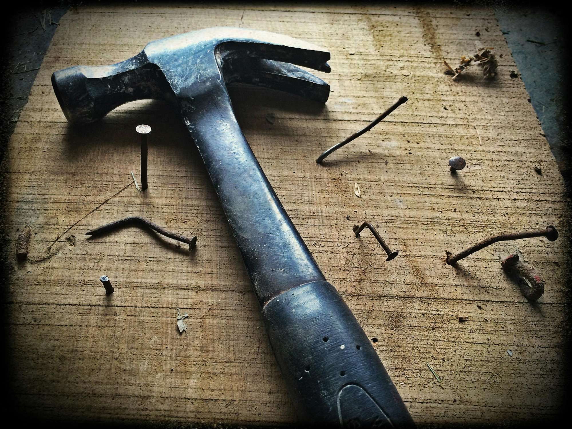 A hammer surrounded by nails