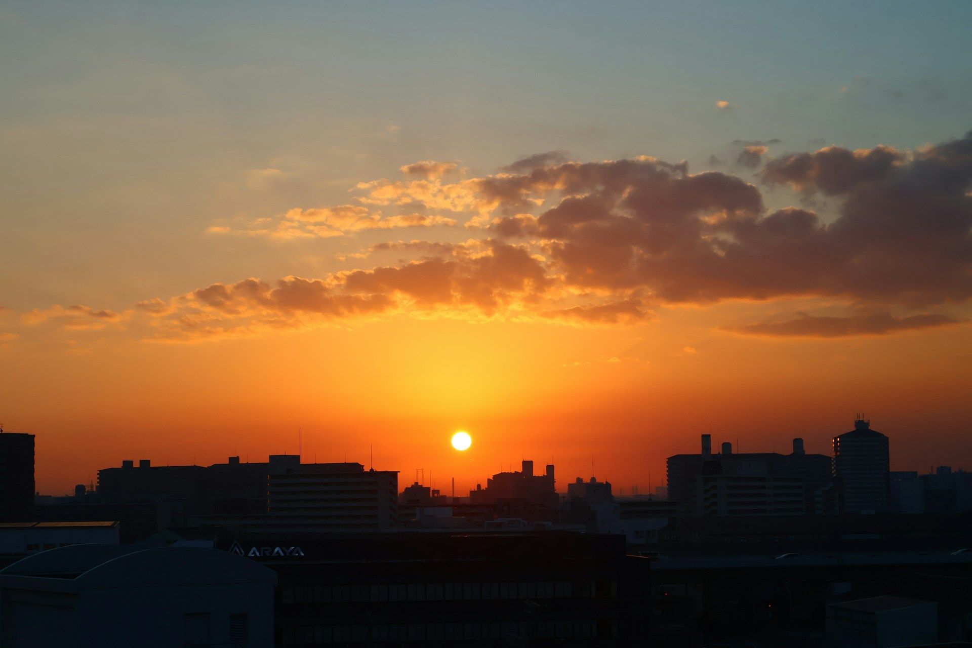 A landscape photograph of the setting sun, evoking a poignant sense of life fading away—which is to say, of mono no aware